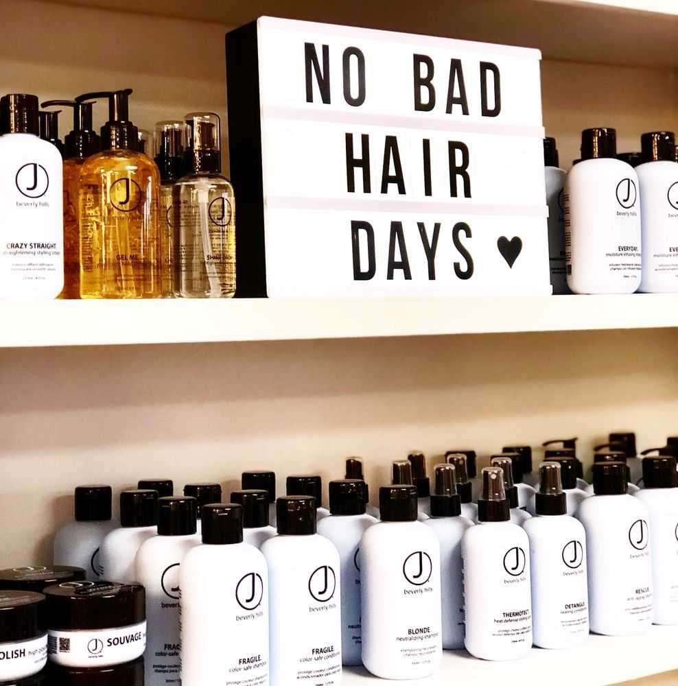Haircare products on shelves with "No Bad Hair Days" sign above.